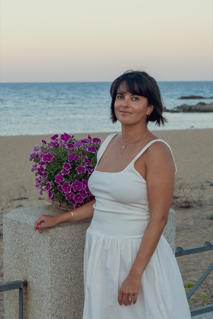 Masha, founder of OMANIT, at the Mediterranean seaside at dusk