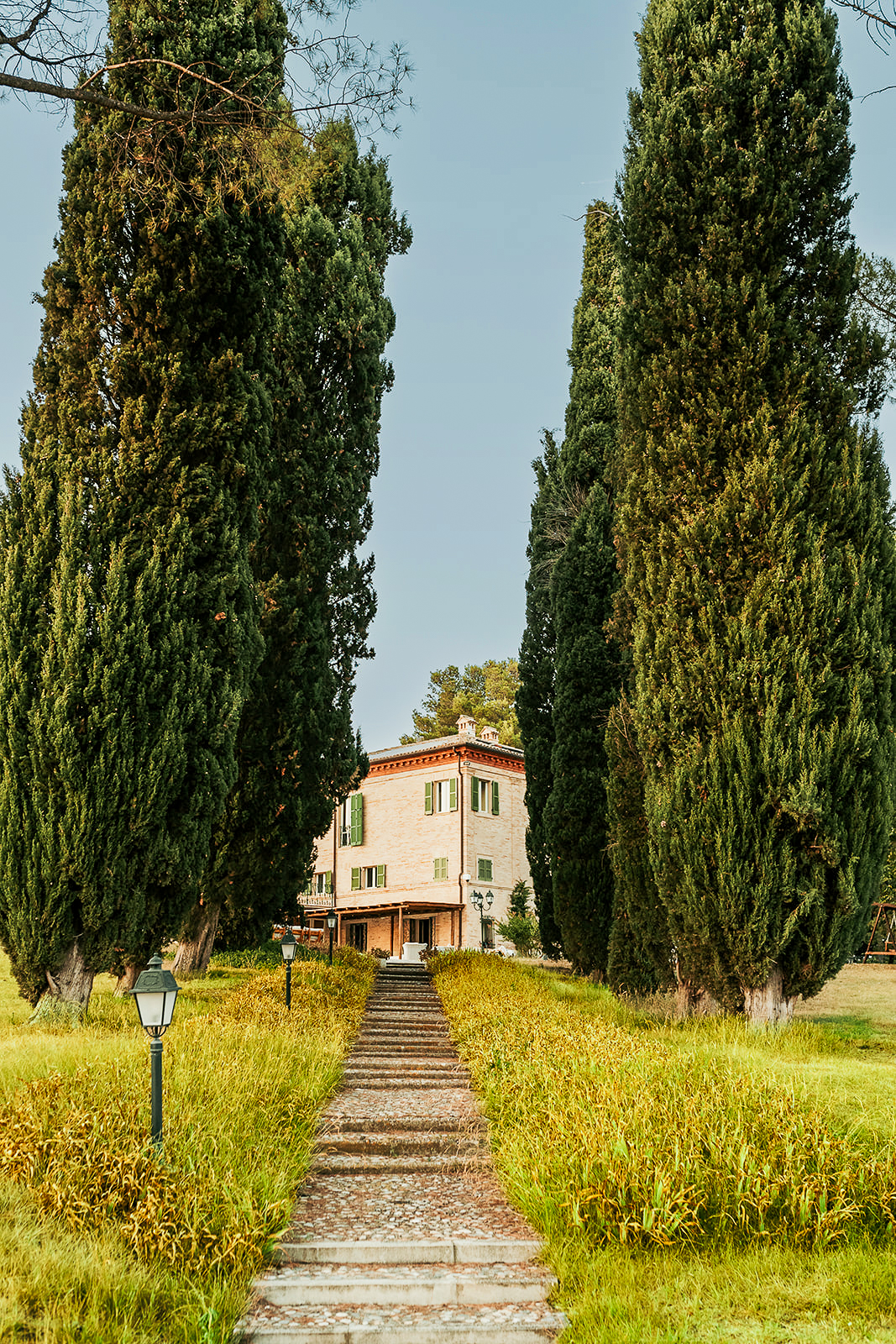 The approach to Maniero Montecassiano through a double avenue of cypress trees